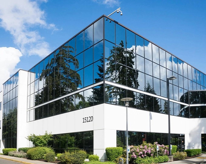 A building with many windows and trees in front of it