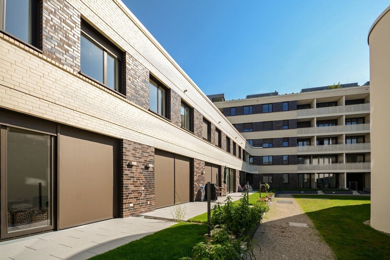 A building with two garage doors and a walkway.